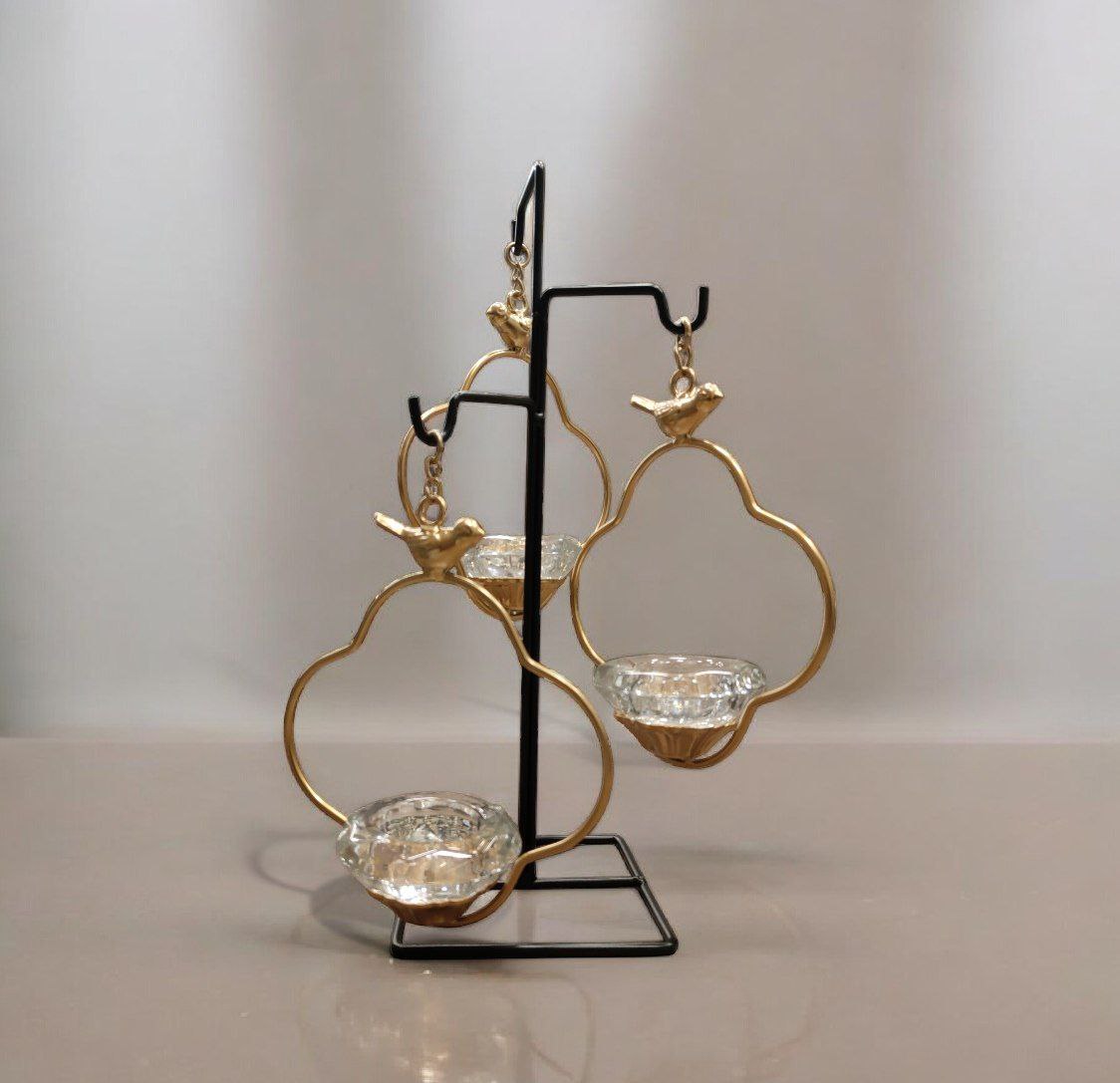Three-legged bird candle holder