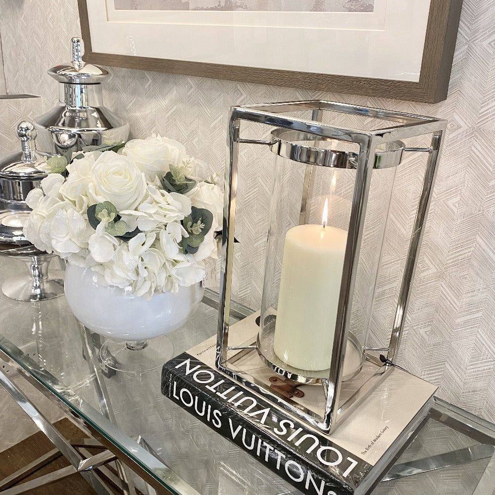 Candle holder made of metal and glass