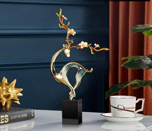 Metal deer decor with a marble base,